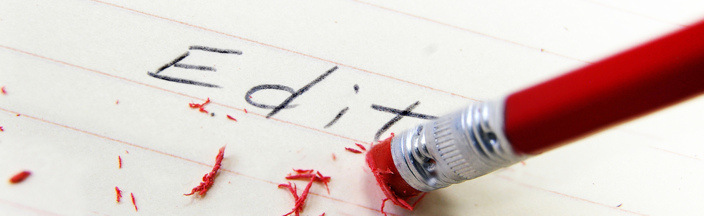 the word edit with a pencil eraser rubbing it out. 