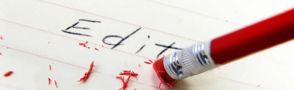 the word edit with a pencil eraser rubbing it out. 